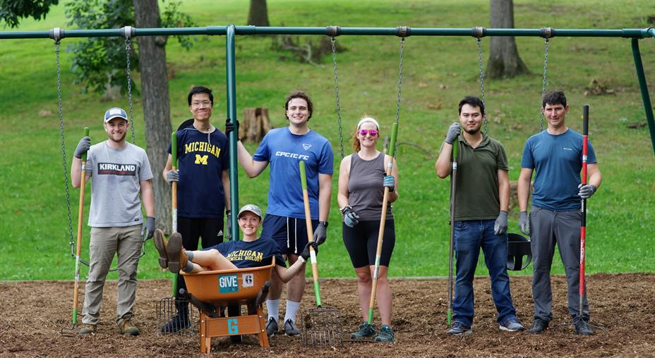GIVE 365 volunteers help pull weeds & spread new woodchips on park playgrounds.